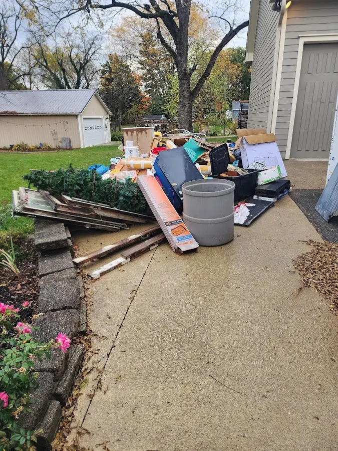 Dumpster being loaded with debris for Roofing Dumpster Rental in Huguley